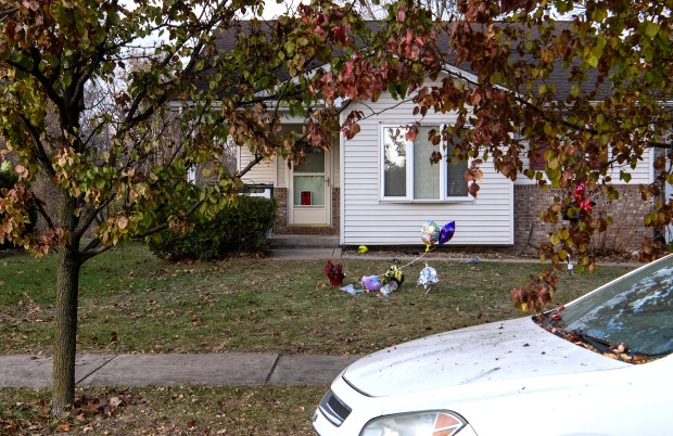 Balloon memorials decorate the lawn of the home where Charles Manville fatally shot his wife Brandy on Nov. 29, 2024, and critically injured his daughter before turning his gun on himself Monday Dec. 2, 2024 in Portage, Indiana.(Andy Lavalley/for the Post-Tribune)