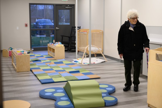 Valparaiso resident Lois Reiner takes a tour of the infant care room during a ribbon-cutting celebration for the NEO Creekside Early Learning Center in Portage on Tuesday, Dec. 3, 2024. (Kyle Telechan/for the Post-Tribune)