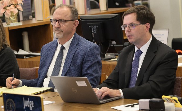 IURC Chairman James Houston (left) and Greg Loyd, Administrative Law Judge and IURC Administrator, listen to citizen complaints during the Indiana Utility Regulatory Commission hearing on NIPSCO's proposed 22% electric rate increase, which would drive up residential customers' monthly bills by around $45. The meeting took place at the Carter G. Woodson Branch Library in Gary on Thursday, Dec. 5, 2024. (John Smierciak / Post-Tribune)