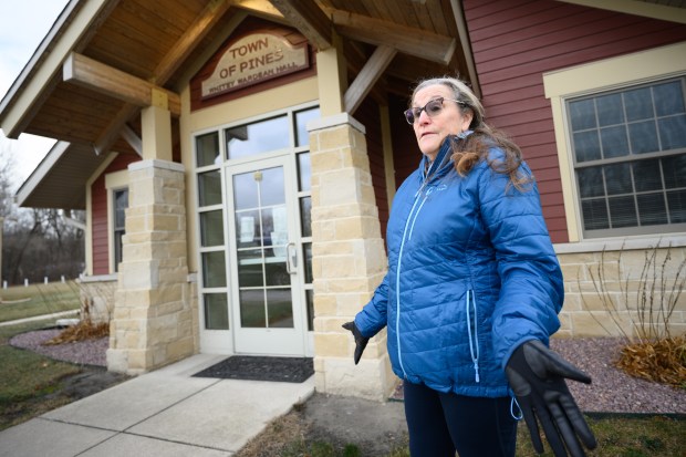 Town of Pines resident Cathi Murray, who is part of a community group to provide input on coal ash cleanup, talks about previous cleanup operations in front of the town hall on Thursday, Dec. 12, 2024. (Kyle Telechan/for the Post-Tribune)