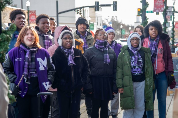 Members of the Merrillville High School Vocalteens choral group sing holiday carols during Small Business Saturday in downtown Hobart on Saturday, Nov. 30, 2024. (Michael Gard/for the Post-Tribune)