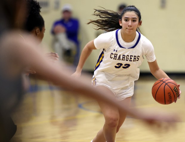 Aurora Central Catholic's Sofia Corral (33) drives against Metea Valley during a nonconference game in Aurora on Monday, Dec. 4, 2023.