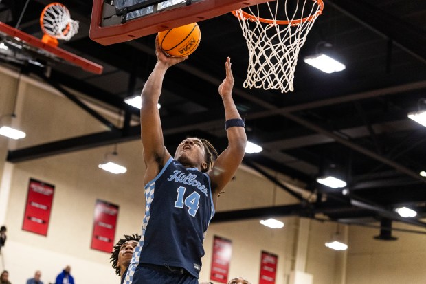 Hillcrest's Maximilian Carmicle (14) puts up a shot against Crete-Monee during a Big Dipper second-round game at Rich Township in Richton Park on Friday, Dec. 27, 2024. (Vincent D. Johnson / for the Daily Southtown)