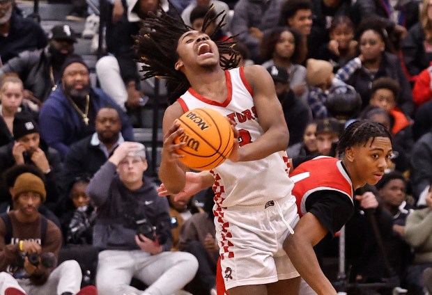 RichTownship's Jamson Coulter Jr. (left) cries out in pain as he takes an elbow from Homewood-Flossmoor's Darrius Hawkins (right) during the Big Dipper Championship game on Sunday, Dec. 29, 2024. (John Smierciak / Daily Southtown)