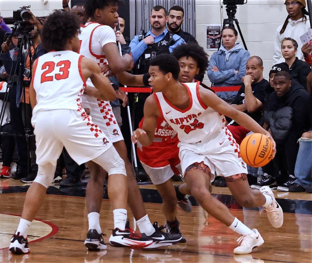 As Rich Township's Nyshawn Turner (23) throws a pick, Jayden Williams (25) drives around him during the Big Dipper Championship game against Homewood-Flossmoor on Sunday, Dec. 29, 2024. (John Smierciak / Daily Southtown)