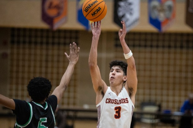 Brother Rice's Marcos Gonzales (3) shoots over Oak Lawn's Donte Montgomery (5) during the Team Rose Shootout at Mount Carmel in Chicago on Saturday, Dec. 14, 2024. (Vincent D. Johnson / for the Daily Southtown)