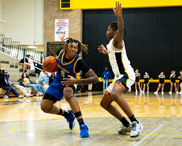 Crete Monee's Jaylen Blakes (0) dribbles around Richards' Travon Gourdine (4) during a game at Richards High School in Oak Lawn on Tuesday, Dec. 17, 2024. (Nate Swanson / for the Daily Southtown)