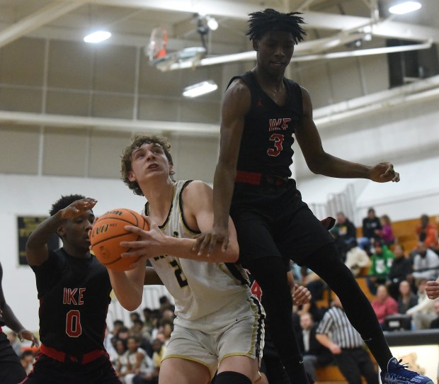 Oak Forest's Hayden Noha (25) tries to get a shot off against Eisenhower's Micah Calvin (3) during a South Suburban Conference game Friday, Dec. 6, 2024 in Oak Forest, IL. (Steve Johnston/for the Daily Southtown)