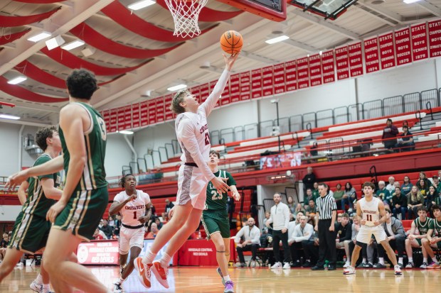 Brother Rice's Caden Workman (21) scores a layup against Lane Tech during a semifinal game in the Hinsdale Central Holiday Classic in Hinsdale on Saturday, Dec. 28, 2024. (Troy Stolt / for the Daily Southtown)