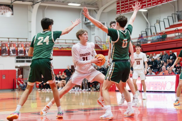 Brother Rice's Caden Workman (21) drives to the basket against Lane Tech during a semifinal game in the Hinsdale Central Holiday Classic in Hinsdale on Saturday, Dec. 28, 2024. (Troy Stolt / for the Daily Southtown)