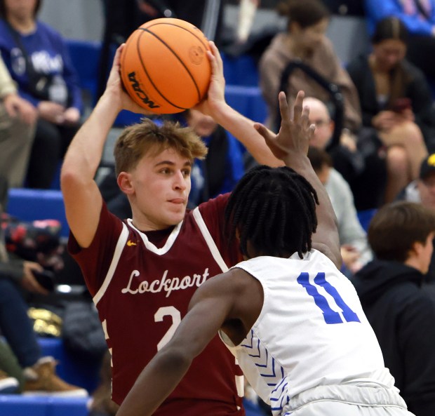 Lockport's Bryce Turner passes the ball as Lincoln-Way East's Jaymon Hornsby defends during the basketball game in Frankfort on Friday, Dec.12, 2024. (James C. Svehla / for the Daily Southtown)