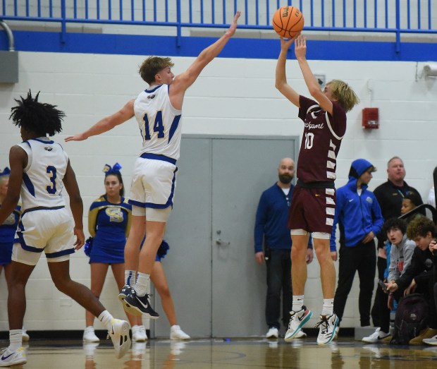 Sandburg's Connor Gleason (14) contests a shot attempt by Lockport's Nojus Venkus (10) during a SouthWest Suburban Conference game Monday, Dec. 16, 2024 in Orland Park, IL. (Steve Johnston/for the Daily Southtown)