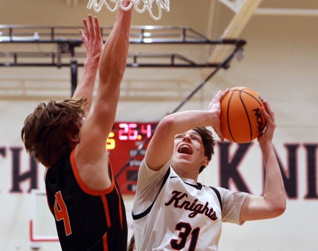 Lincoln-Way Central's Jack Rimkunas goes for the net as Lincoln-Way West's Ethan Swanson defends during the basketball game in New Lenox on Friday, Dec. 20, 2024. (James C. Svehla / for the Daily Southtown)