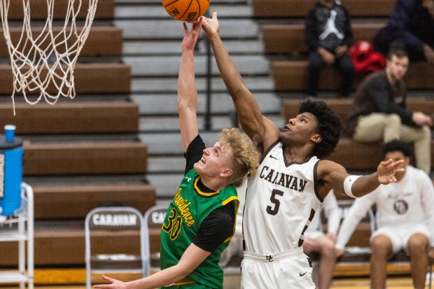 Providence's Seth Cheney (30) and Mount Carmel's Cameron Thomas (5) go up for a rebound during a Catholic League crossover game in Chicago on Tuesday, Dec. 10, 2024. (Vincent D. Johnson / for the Daily Southtown)