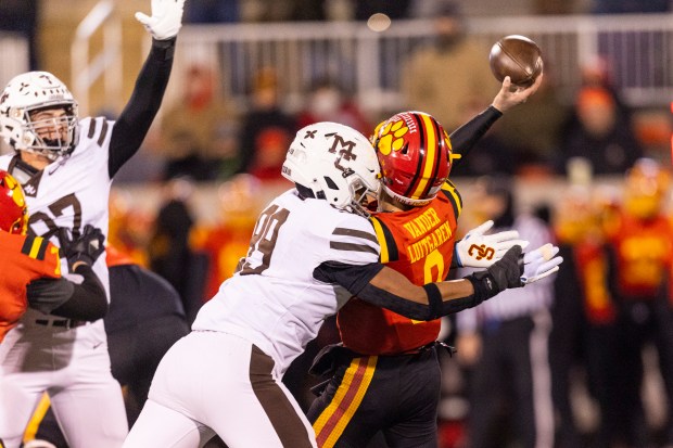 Mount Carmel's Braeden Jones (99) hits Batavia's Michael Vander (8) as he passes in the Class 7A state championship game at Hancock Stadium in Normal on Saturday, Nov. 30, 2024. (Vincent D. Johnson / for the Daily Southtown)