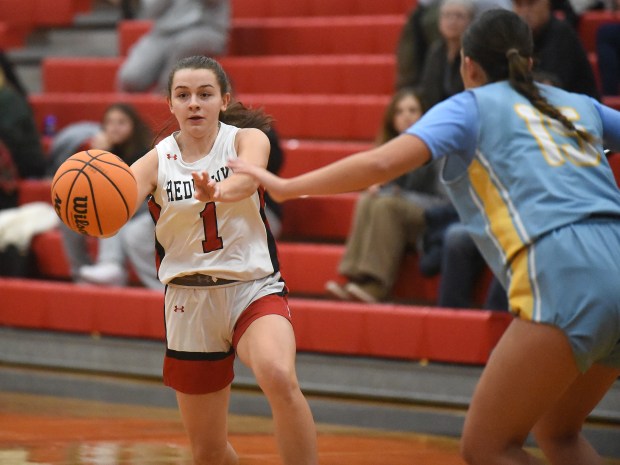 Marist's Olivia Cosme (1) dishes a pass against Joliet Catholic during an East Suburban Catholic Conference game Monday, Dec. 2, 2024 in Chicago, IL. (Steve Johnston/for the Daily Southtown)