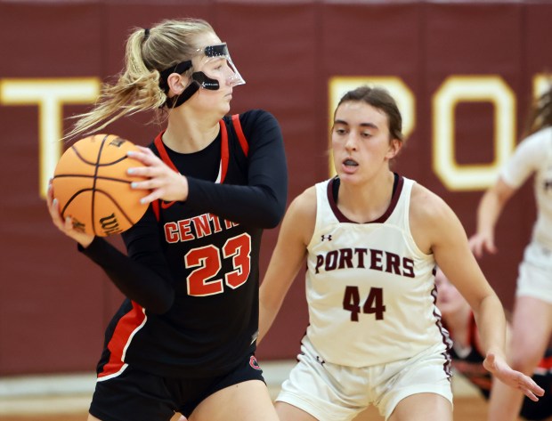 Lincoln-Way Central's Brooke Baechtold passes the ball as Lockport's Alaina Peetz defends during the girls basketball game in Lockport on Tuesday, Dec. 10, 2024. (James C. Svehla / for the Daily Southtown)