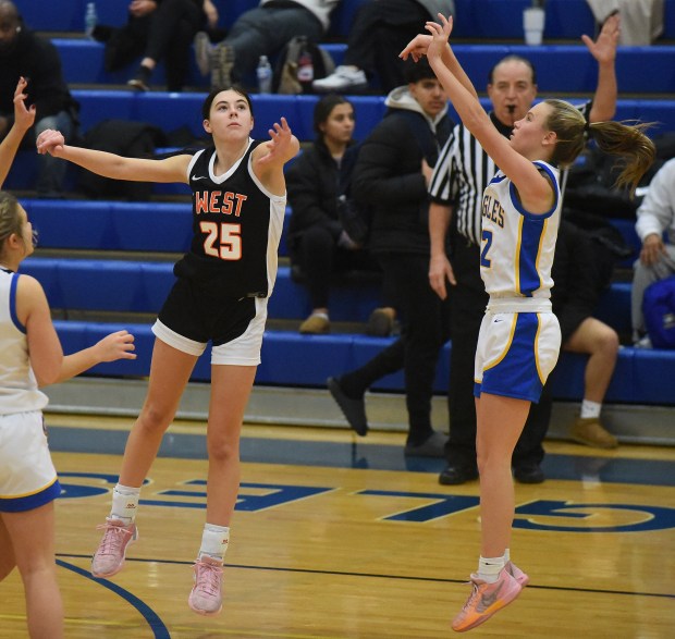 Lincoln-Way West's Mackenzie Roesner (25) defends Sandburg's Zoe Trunk (12) during a SouthWest Suburban Conference game Thursday, Dec. 12, 2024 in Orland Park, IL. (Steve Johnston/for the Daily Southtown)