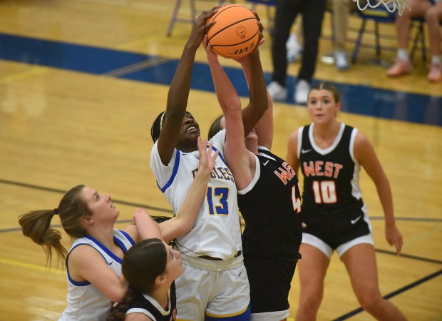 Sandburg's Monique Nkwogu (13) and Lincoln-Way West's Reagan McCracken (42) battle for the rebound during a SouthWest Suburban Conference game Thursday, Dec. 12, 2024 in Orland Park, IL. (Steve Johnston/for the Daily Southtown)