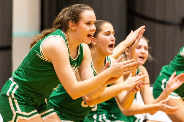 Providence's Taylor Healy (21) cheers on her teammates from the bench after getting a large lead against Hillcrest during the Marian Catholic Holiday Tournament in Chicago Heights on Wednesday, Dec.18, 2024. (Vincent D. Johnson / for the Daily Southtown)