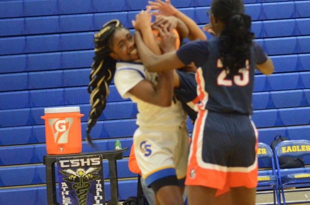 Sandburg's Monique Nkwogu, left, battles two Romeoville players for a rebound in the quarterfinals of the Sandburg Holiday Classic in Orland Park on Thursday, Dec. 26, 2025. (Jeff Vorva / Daily Southtown)