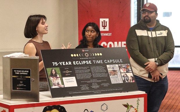 Students Haley Weiland (from left) Mariam Ameeruddin and Hamza Nasir speak of their experiences at the eclipse durning the IUN Time Capsule Sealing Ceremony. The capsule will preserve some of the memories and materials from April 8's solar eclipse. The capsule isn't set to be opened until 2099 when the next eclipse rolls around. The closing ceremony took place on Monday, Dec. 9, 2024. (John Smierciak / Post-Tribune)