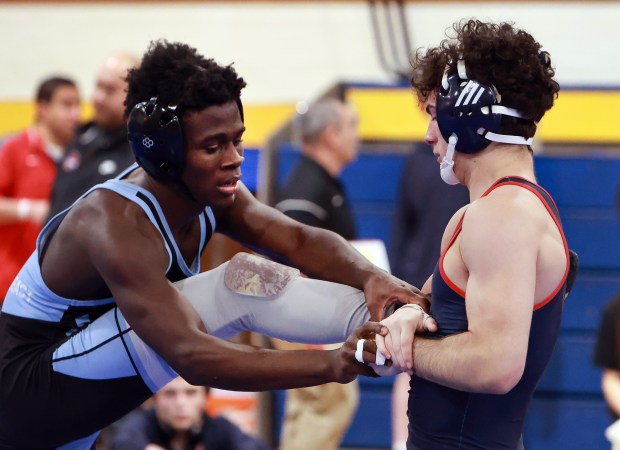 St Rita's Enzo Canali, right, and Belleville East's Dewayne Taylor, left, during the 144 weight class McLaughlin Classic wrestling meet at Joliet Central High School in Joliet on Saturday, Dec. 7, 2024. (James C. Svehla / for the Daily Southtown)