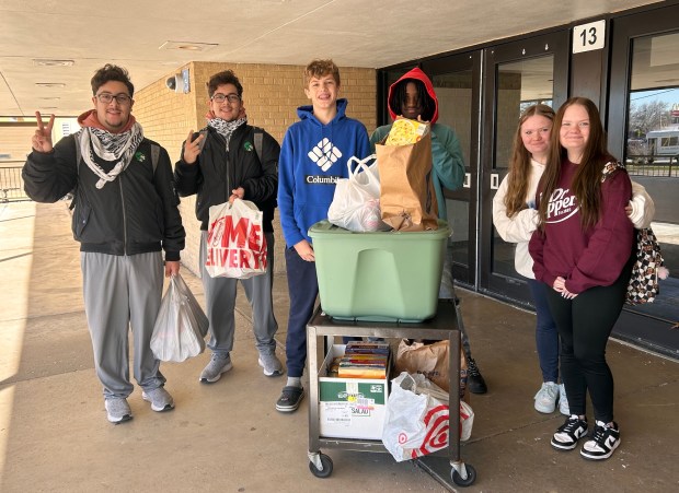 Standing with some of the food and other items collected for Oak Lawn Community High School's Thanksgiving food drive, from left, are freshmen Hussien Omari, Mohammed Omari, Carter Shane, Lamont Graham, Katie Swiatek and Hailey Swiatek. (Oak Lawn Community High School)