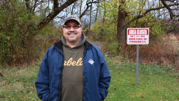 Joel Gomez, of Blue Island, stands at trail entrance near a deer hunting area recently established at the north end of William W. Powers State Recreation Area on Chicago's Southeast Side. (Susan DeGrane/Daily Southtown)