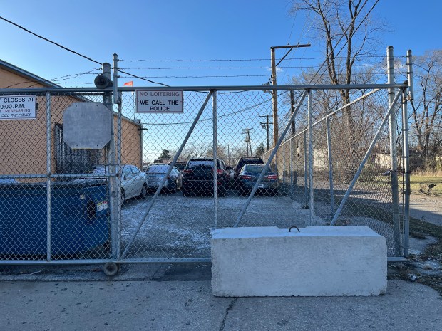 A cement barricade blcoks the rear entrance at Michael Motors in Harvey Dec. 5, 2024. (Samantha Moilanen/Daily Southtown)