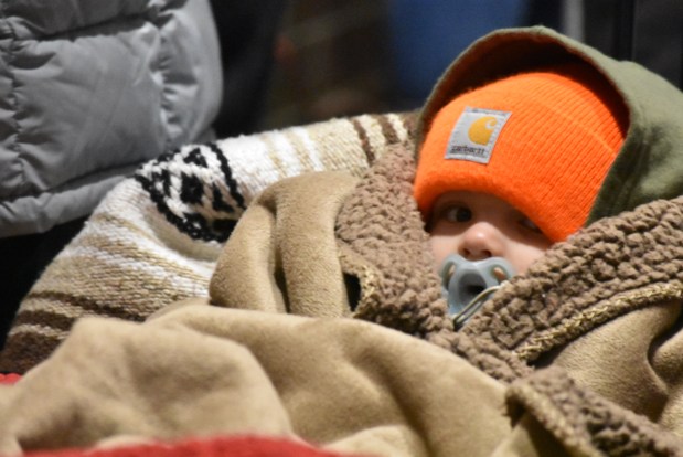 Wyatt Mollet sits bundled up against temperatures in the teens Nov. 30, 2024, in line to see Santa Claus in New Lenox. (Jesse Wright/for the Daily Southtown)