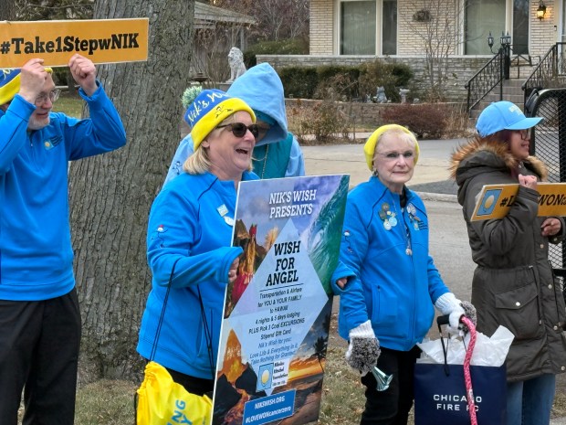 A group from the Rockford-based Nik's Wish organization gets ready to surprise Oak Lawn's Angel Santiago with a trip to Hawaii Dec. 19, 2024. (Jeff Vorva/for the Daily Southtown)