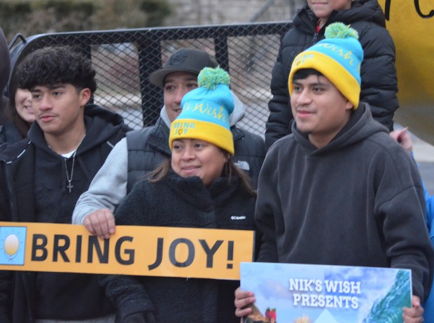 Angel Santiago, right, and his mother, Anaiz Diaz, after Santiago was surprised with a trip to Hawaii Dec. 19, 2024, in Oak Lawn. (Jeff Vorva/for the Daily Southtown)