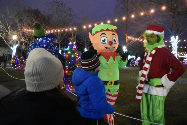 The Grinch is less than impressed with some children Dec. 7, 2024, at Santa on the Green. (Jesse Wright/for the Daily Southtown)