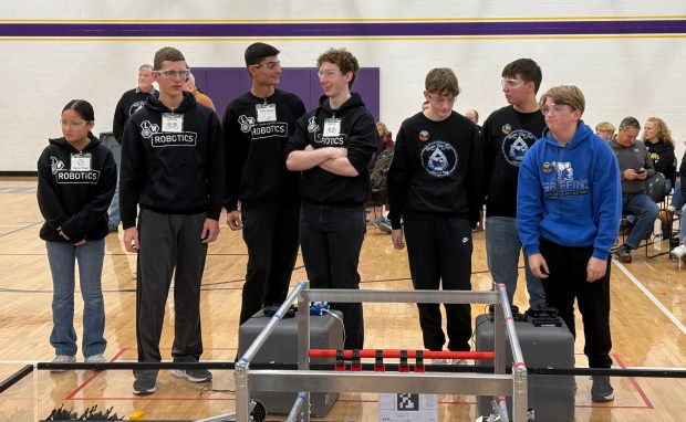 Robotics team members from Lincoln-Way Central and Lincoln-Way East, who collaborated for a match, await the results Dec. 14, 2024, at Chicago Christian High School. (Jeff Vorva/for the Daily Southtown)