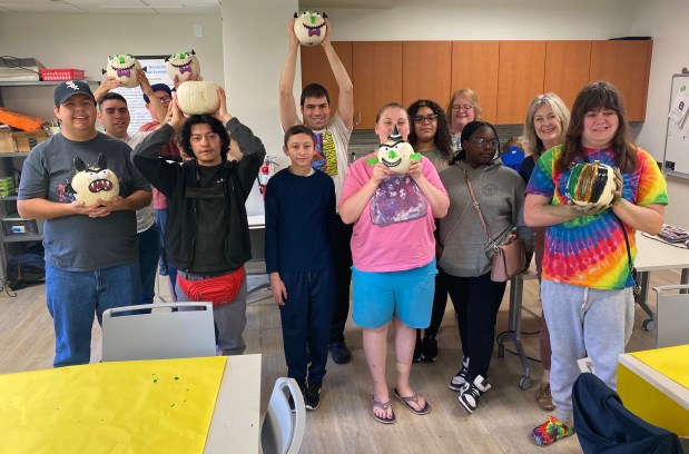 Stacks Social Club members hold pumpkins they decorated during the monthly meeting in Oct. at the Evergreen Park Public Library. (Evergreen Park Public Library)