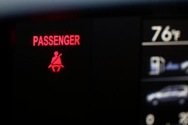 A seat belt warning sign for the right front passenger seat is displayed in a vehicle on Monday, Aug. 21, 2023. (AP Photo/Jenny Kane, file)