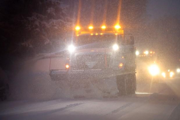 Snowplow trucks work Oak Park Avenue in Berwyn as a winter storm hits the Chicago area with near-blizzard conditions on Jan. 12, 2024.