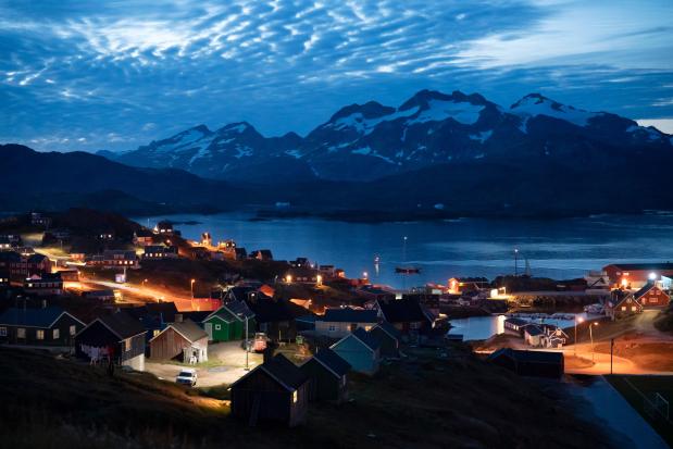 Homes are illuminated after the sunset in Tasiilaq, Greenland, Friday Aug. 16, 2019.(AP Photo/Felipe Dana, File)