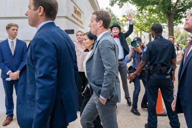 FILE - Meta CEO Mark Zuckerberg passes media and a protester as he arrives for a closed-door gathering of leading tech CEOs to discuss the priorities and risks surrounding artificial intelligence, on Capitol Hill in Washington, on Sept. 13, 2023. (AP Photo/Jacquelyn Martin, File)