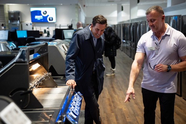 David Henry of Hinsdale, left, looks at grills at Abt Electronics in Glenview with the assistance of Larry Rivlin on Nov. 21, 2024. (E. Jason Wambsgans/Chicago Tribune)