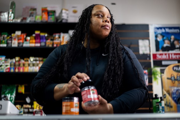 Brandy Garner with delta-8 THC products at her store, Brandy's CBD, on Dec. 13, 2024, in Chicago's Chatham neighborhood. (Tess Crowley/Chicago Tribune)