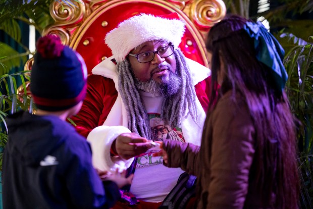 Andre Russell greets people as Dreezy Claus on Nov. 24, 2024, during the Millennium Park Holiday Market. (Brian Cassella/Chicago Tribune)