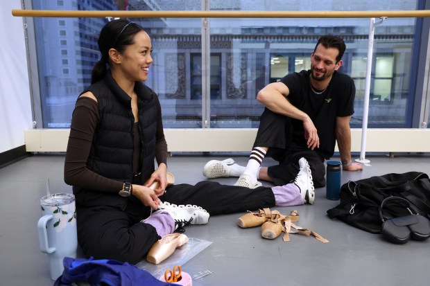 Joffrey Ballet dancers Jeraldine and Dylan Mendoza-Gutierrez relax on their lunch break in a rehearsal space in Joffrey Tower in Chicago on Nov. 25, 2024. Because they are usually working on Christmas, they send gifts to family early so they can enjoy them on the holiday. (Terrence Antonio James/Chicago Tribune)