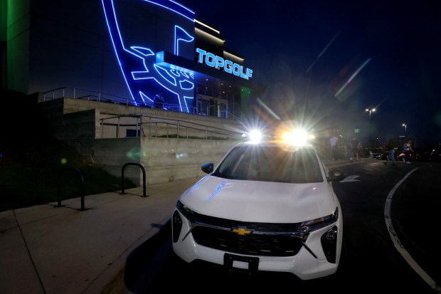 A private security vehicle sits outside the entrance to Topgolf in Naperville on April 13, 2024. Repeated gun-related arrests have occurred as a result of police spotting guns in plain view of parked cars on the property. (Chris Sweda/Chicago Tribune)