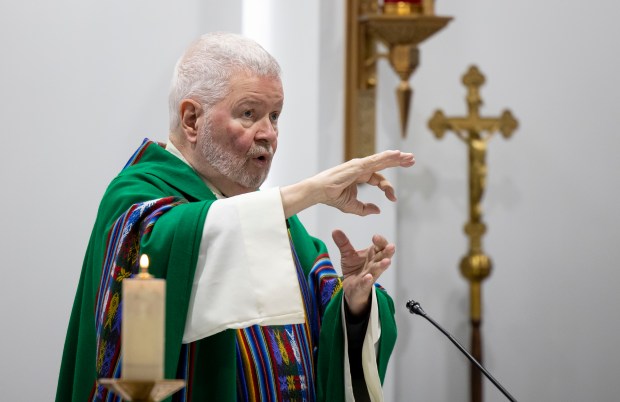 The Rev. Joseph Mulcrone, director of the Archdiocese of Chicago's Catholic Office of the Deaf, signs his homily during a Mass held for deaf parishioners on Oct. 13, 2024, at St. Francis Borgia. (Brian Cassella/Chicago Tribune)