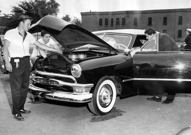 Fred Lorenzen, of Elmhurst, shows off his custom 1950 Ford with a 1954 Cadillac engine with 350 horse power at the All Class Auto Show held at the Illinois Institute of Technology in Chicago on May 7, 1955. Next to Lorenzen is E.G. Braner, of Chicago, back left, and Bruce Mann, of Chicago, on right. (Phil Mascione/Chicago Tribune) 