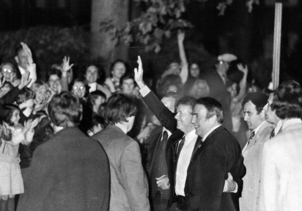 At President Jimmy Carter's first stop, the home of Newton Minow in Glencoe, throngs of young people turned out to wave and stare as President Carter and Rep. Abner Mikva, right, as they waved back on Nov. 2, 1978. (Quentin C. Dodt/Chicago Tribune) 