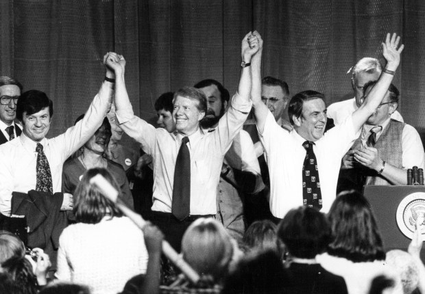 The heat in the Niles East High School gym was too much for President Jimmy Carter, center, at a rally on Nov. 2, 1978. He doffed his jacket and Sen. Adlai Stevenson, right, followed suit. Gubernatorial candidate Michael Bakalis, left, President Carter and U.S. Rep. Mikva, both sans jackets, acknowledge the applause. (Carl Hugare/Chicago Tribune) 