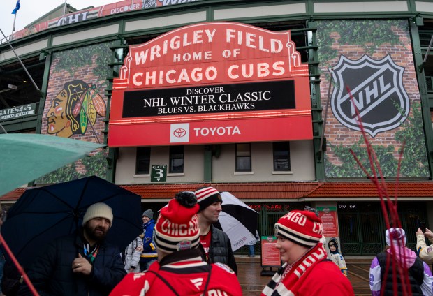 Fans arrive under the marquee on Dec. 31, 2024, before the Blackhawks faced the Blues in the NHL Winter Classic at Wrigley Field. (Brian Cassella/Chicago Tribune)